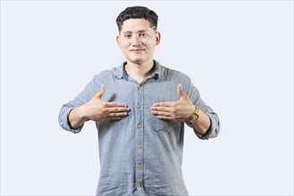 Interpreter person gesturing HAPPINESS in sign language. Smiling young man gesturing HAPPINESS in