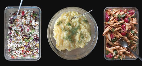 Rice and potato and pasta salad in glass bowls on a black background, Bavaria, Germany, Europe