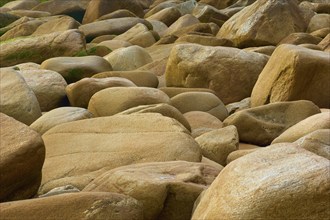 Rocky beach with beige stones in different sizes, natural texture and calm atmosphere, Quiberon,