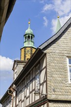 Artful half-timbered houses in the old town with a view of the Goslar Market Church of St Cosmas