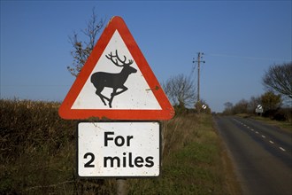 Road sign warns of deer for 2 miles ahead