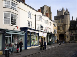 Shops in Market Place with Penniless Porch and the cathedral, Wells, Somerset, England, United