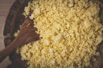 Cooked couscous, in a wooden bowl, top view, no people