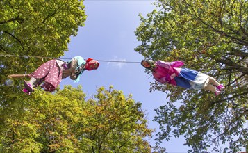 A witch, the mascot of the 114th German Hiking Day, hangs from a lofty height in Bad Harzburg,