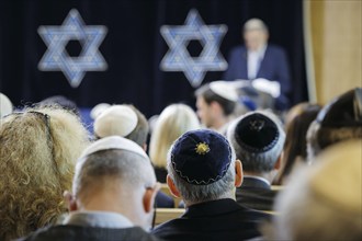 Men with kippas sit in the synagogue during the inauguration of the synagogue centre in Potsdam