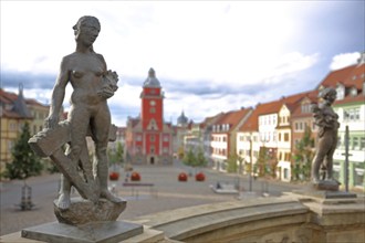 Two sculptures Prudentia and Caritas by Bernd Göbel 2021 on balustrade with blurred Old Town Hall,