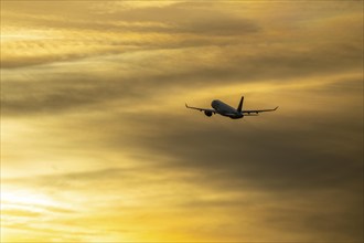 Aeroplane after take-off from Düsseldorf airport, sunset