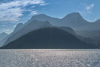 Norddalsfjord, view from the Linge ferry terminal to the south, backlit mountain ranges, near