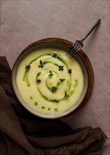 Mashed potatoes, with green butter and micro greenery, homemade, on a beige table, no people, top