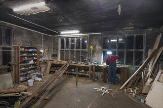 Young man working in his workshop in the evening, Mecklenburg-Vorpiommern, Germany, Europe