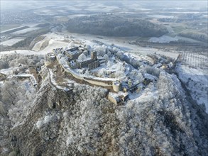 Aerial view of snow-covered Hegau volcano Hohentwiel with Germany's largest castle ruins,