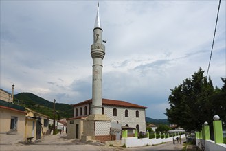 View of a mosque with a slender minaret on a street with pedestrians, Melivia, Melivoia, centre of