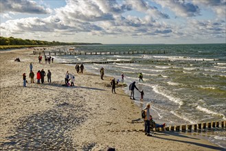 Holidaymakers at the Zingst pier, cloudy mood and waves, Baltic Sea coast, Zingst,