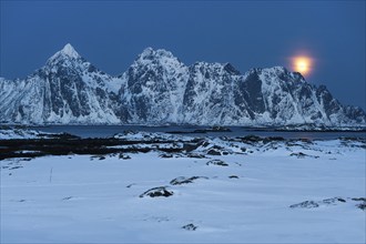 Moonrise, winter landscape, Lofoten island Vestvågøya at the fjord Gimsøystraumen, Lofoten,