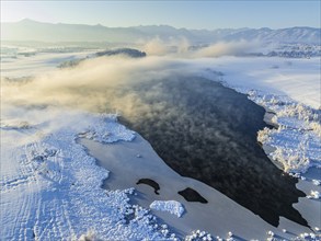 Aerial view of a lake in front of mountains, winter, snow, morning light, fog, Riegsee, Alpine