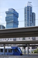 Main railway station with local train with the skyscrapers The Spin and Grand Tower, Frankfurt am