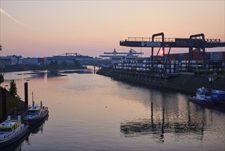 Vincke Canal with container bridge of duisport, Duisburger Hafen AG at sunrise in Ruhrort,