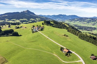 Aerial view of rural road in meadows, ridge Elleghöhe near Wertach, mountain Grünten in the back,