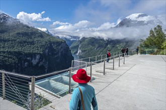 Tourists takes pictures, viewpoint Ørnesvingen above the Geirangerfjord, Norway, Europe