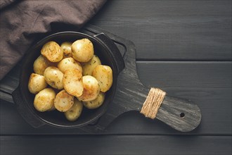 Fresh Cooked, new potatoes, with dill, on a wooden table, selective focus. close-up, toning, no