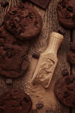 Dark chocolate cookies, with chocolate chips, on a wooden table, selective focus, close-up, no