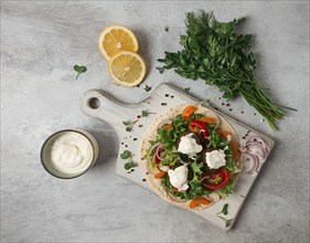 Tortilla with falafel and vegetable salad, white sauce, Arabic cuisine, top view, homemade, no