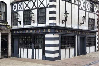 Historic half-timbered building with lanterns on the corner of a cobbled street, Waterford