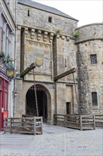 Stone portal with medieval design and chains, part of an old fortress, Le Mont-Saint-Michel