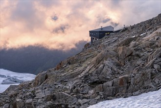 Mountain hut Refuge Albert 1er, high alpine mountain landscape at sunset, Glacier du Tour,