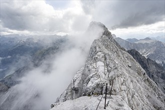 Clouds around a narrow rocky ridge, Watzmann crossing to Watzmann Mittelspitze, view of mountain