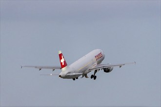 A Swiss aeroplane takes off into the sky with a clear blue background, Stuttgart