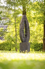 Wooden sculpture in a park, green trees and sunny weather, Nagold, Black Forest, Germany, Europe