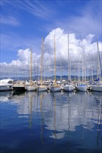 Water reflection, sailing boats in the harbour of Saint Tropez, Var, French Riviera,