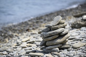 Stacked stones on a pebble beach by the sea