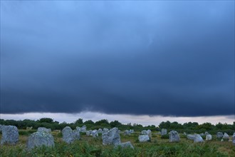 Neolithic menhirs, standing stones in Carnac with dramatic stormy sky, Carnac, Quiberon, Morbihan,