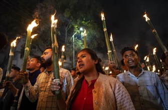 Members of the All Assam Students' Union (AASU) take part in a flaming torch rally and shout