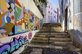 A colorful street art mural lines a staircase in an urban alleyway, adding vibrancy to the city,