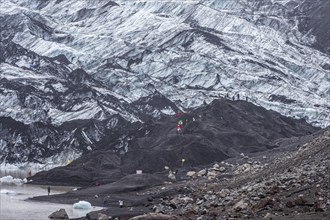 Tourist groups at a glacial lake, glacier hike, glacier solheimajökull, icebergs on the lake,