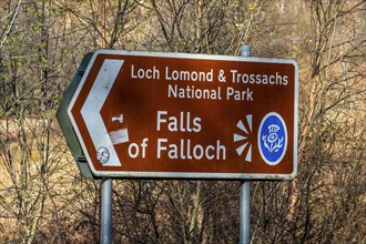 Signpost, waterfall Falls of Falloch, Loch Lomond NP, Scotland, UK