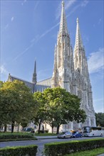 Neo-Gothic church with high towers and green surroundings, Vienna