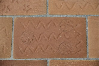 Brick kiln with zigzag design and circular patterns, on a tiled floor, Patmos Cotto Brickworks,