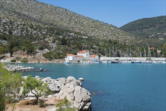 Harbour with boats in front of a picturesque mountainous landscape by the sea, harbour of Methana,