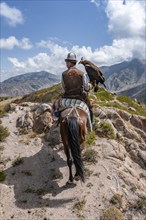 Traditional Kyrgyz eagle hunter, near Kysyl-Suu, Kyrgyzstan, Asia