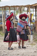 Peruvian woman in traditional traditional costume at the indigenous market in Chinchero, Cusco