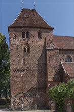 Church of the former convent of the Benedictine nuns 13th century, in front medieval crane wheel