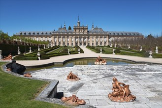 Magnificent palace with fountains, statues and manicured gardens under a blue sky, Royal Castle La