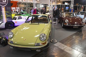 Visitors to Techno Classica take a look at Porsche 911 models. Techno Classica is the trade fair