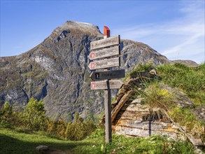 Signpost at Alpe Homlongsætra above the Geirangerfjord, traditional summer farm, Geirangerfjord,