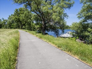 Havel cycle route, route between city Brandenburg and village Werder, leisure boats anchor at bank