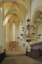 Choir room with altar and choir stalls, interior view, Gothic, chandelier, high altar with